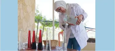  ?? Agence France-presse ?? ↑
Zahraa Sayed Ahmed produces rose water from Damascena roses at her house in Qsarnaba on Wednesday.