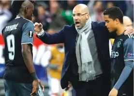  ??  ?? Ajax’s coach Peter Bosz, centre, gives directions to Bertrand Traore during the second leg of the Europa League semifinal against Lyon Photo: AP