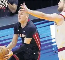  ?? LAVANDIER/AP MARTA ?? Cleveland Cavaliers forward Dean Wade (32) defends against Miami Heat guard Tyler Herro (14) during the first half Saturday in Miami.