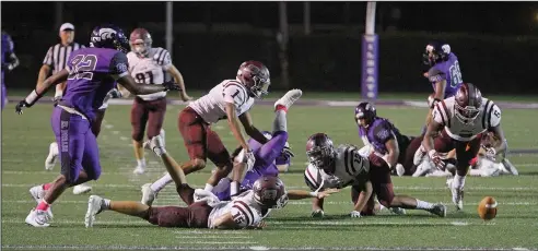  ?? Terrance Armstard/News-Times ?? Greasy pigskin: Benton's Kyvin Carroll dives on a fumble by an El Dorado ball carrier. The Wildcats lost two fumbles and threw two intercepti­ons but still managed to hold on for a 27-20 victory over the Panthers Friday at Memorial Stadium.