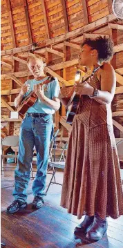  ??  ?? Jeff Howard, president of the OKC Ukulele Group, plays with Janice Francis-Smith on Sunday.