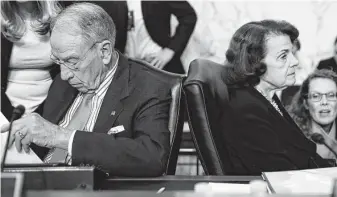  ?? Alex Brandon / Associated Press ?? Senate Judiciary Committee Chairman Chuck Grassley, R-Iowa, and Sen. Dianne Feinstein, D-Calif., the top Democrat on the committee, work with aides during a break in the hearings.