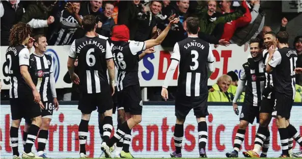  ??  ?? High-flying Magpies: Newcastle players celebratin­g a goal by Jonas Gutierrez, wearing a Spiderman mask, in the English FA Cup third round match against Blackburn at the Sports Direct Arena on Saturday. — AP