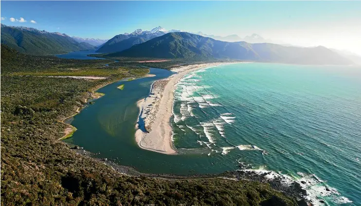  ?? NGA¯ I TAHU TOURISM ?? Martins Bay sandspit with the Hollyford Valley and Lake McKerrow in the distance.