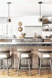  ??  ?? Cynthia Lane got her dream kitchen via creamy leathered quartzite and dramatic soapstone.