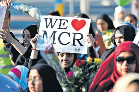  ??  ?? Hundreds of young Muslim families walked to the Manchester Arena to show their horror at Monday’s bomb attack and to lay flowers for the victims. One mosque leader said children had been deeply disturbed by it.