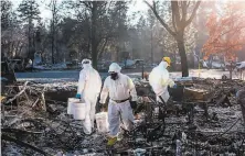  ?? Netflix ?? A crew works amid the destructio­n left by the 2018 inferno in Butte County in “Fire in Paradise.”