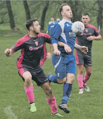  ??  ?? Herrington CW (blue) try to control the ball under pressure from Pennywell Comrades. Picture by Kevin Brady.