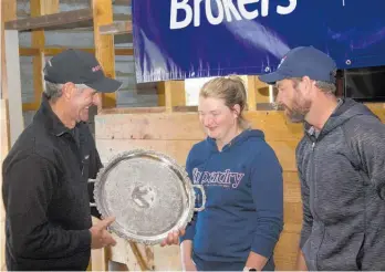  ??  ?? Sam Ellingham, MCI & Associates, presents Fiona and Shaun Fouhy with the trophy for winning the Property Brokers Tararua Sheep and Beef Farm Business if the Year award.