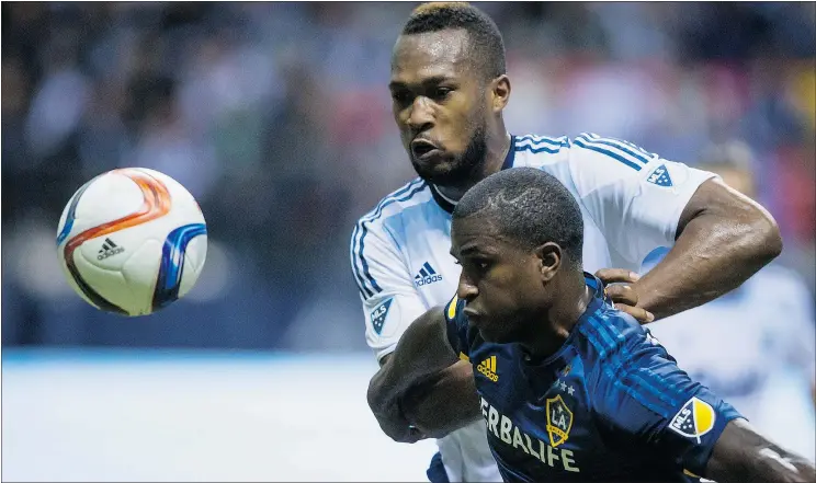  ?? — CP FILES ?? L.A.’s Edson Buddle and Whitecaps’ Kendall Waston, back, chase the ball. Waston said he’s not surprised he was left off the Costa Rican national team for the Gold Cup.