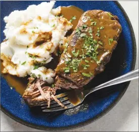  ?? The Associated Press ?? This photo by America's Test Kitchen shows a short rib pot roast with mashed potatoes.