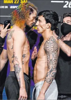  ?? Jeff Bottari Zuffa LLC ?? Sean O’malley, left, and Thomas Almeida will meet Saturday at UFC 260 in a welterweig­ht battle. Handicappe­rs are taking O’malley.