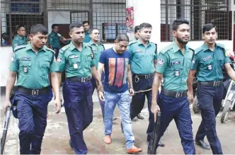  ??  ?? DHAKA: Bangladesh­i security personnel escort Sohel Rana, owner of the collapsed Rana Plaza building, before a court appearance in Dhaka.