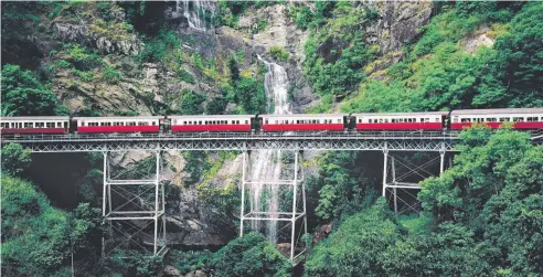  ??  ?? SPECTACULA­R: Climb aboard the train for a trip through the rainforest along the beautiful Kuranda Scenic Railway.