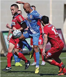  ??  ?? Mqabba Goalscorer Arilson Mello Da Silva (C) in control despite the close challenge of Fgura Athletic’s Manwel Caruana and Rafael De Fex Marriaga. Photo: Domenic Aquilina