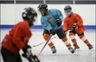  ?? MATT ROURKE - THE ASSOCIATED PRESS ?? In this Feb. 21, 2019photo Malakye Johnson takes part in a Snider Hockey practice at the Scanlon Ice Rink in Philadelph­ia.