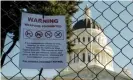  ?? Photograph: John G Mabanglo/EPA ?? A sign reads ‘Warning weapons prohibited’ on a temporary fence outside the state capitol in Sacramento, California, on 17 January.