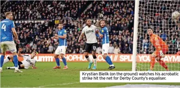  ?? ?? Krystian Bielik (on the ground) watches his acrobatic strike hit the net for Derby County’s equaliser.