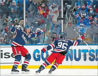  ?? ADAM HUNGER/AP PHOTO ?? Rangers left wing J.T. Miller (10) celebrates scoring the game-winning goal with right wing Mats Zuccarello (36) in overtime during Monday’s NHL Winter Classic against the Sabres at New York.