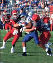  ?? LARRY GREESON / For the Calhoun Times ?? Gordon Central’s Gauge Giddens (22) tries to fight through the tackles of Sonoravill­e’s Kobe McEntyre (2) and Matthew Vincent (24).