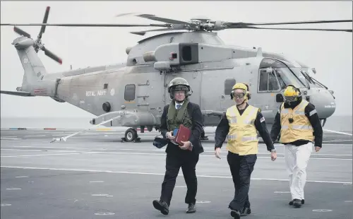  ??  ?? Defence Secretary Sir Michael Fallon, left, who has announced his decision to resign as Defence Secretary, on board HMS Queen Elizabeth yesterday.