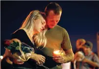  ?? AP ?? Brandon Webb and Carlye Michel participat­e in a candleligh­t vigil in the parking lot of Ride the Ducks in Branson. —