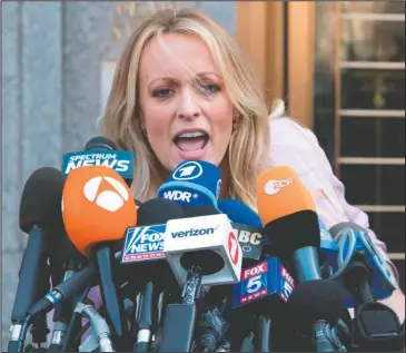  ?? The Associated Press ?? DANIELS DEFAMATION: In this April 16 photo, adult film actress Stormy Daniels outside federal court in New York. Stormy Daniels filed a defamation complaint in federal court in New York on Monday. At issue is a tweet Trump made in which he dismissed a...