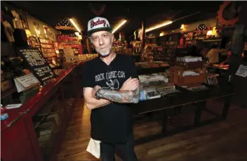  ??  ?? In this Sunday photo, Jim Norris poses for a photo inside his informatio­n cafe called Mutiny in south Denver. Norris is hoping to license his storefront as one of the nation’s first legal marijuana clubs. AP PHOTO/DAVID ZALUBOWSKI