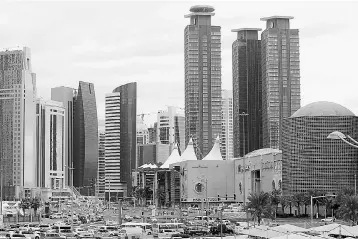  ??  ?? This file photo shows skyscraper­s in the Qatari capital Doha. Qatar has filed a complaint with the World Trade Organizati­on over an ‘illegal siege’ imposed by its Gulf neighbours, the commerce ministry said. — AFP photo