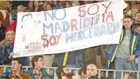 ?? ?? ABOVE: Barcelona fans hold up a sign directed at Luis Figo that translates to "I am not a Madridista, I am a mercenary" in 2000. BELOW: Pep Guardiola avoids eye contact with Jose Mourinho ahead of an ElClasico clash on 27 April 2011.