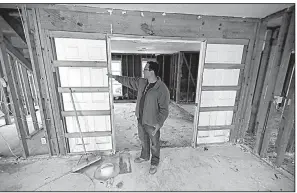  ?? AP/DAVID J. PHILLIP ?? Jacob Lerma on Monday shows how high floodwater­s from Hurricane Harvey reached inside his home in Friendswoo­d, Texas.