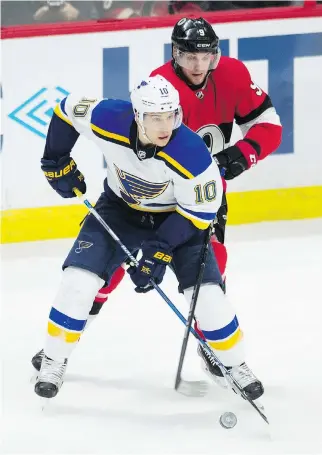  ?? ADRIAN WYLD/THE CANADIAN PRESS ?? Senators right winger Bobby Ryan tries to steal the puck away from St. Louis Blues centre Brayden Schenn during the first period at the Canadian Tire Centre Thursday. The Sens lost 4-1.