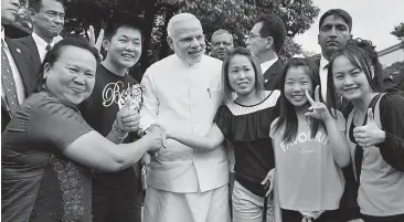  ??  ?? Prime Minister Narendra Modi with tourists during his visit to the Golden Pavilion, a Buddhist temple in Kyoto, Japan, on Sunday. —