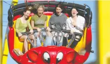  ?? DARREN MAKOWICHUK ?? Rainfall didn't dampen the spirits of thrill seekers attending Sneak-a-peek at the Calgary Stampede on Thursday.