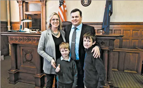  ?? COURTESY OF DANA M. VANSUMEREN ?? The VanSumeren family pose for a photo in a Michigan courtroom after Robert’s swearing-in ceremony in November.