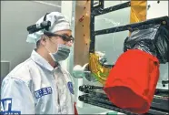  ??  ?? An engineer from the China Academy of Space Technology conducts tests on a Beidou satellite.