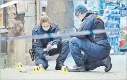  ?? Picture: AP ?? Police officers work near the scene of a shooting, in Malmo, Sweden on Saturday.