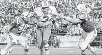  ?? AP photo ?? Buffalo running back O.J. Simpson (32) has his jersey pulled by Baltimore linebacker Mike Curtis during the second quarter of a game in Baltimore, Md., Oct. 12, 1975.