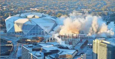  ?? Mike Stewart / AP ?? The Georgia Dome is destroyed in a scheduled implosion next to its replacemen­t the Mercedes-Benz Stadium on Monday in Atlanta.