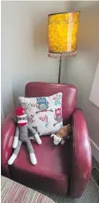  ??  ?? A comfy red leather armchair adds a pop of colour and cosy appeal in the spare bedroom.