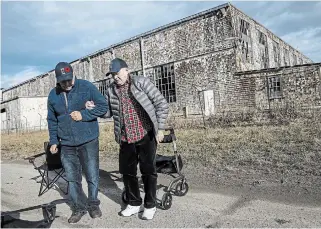  ?? JEFF MCINTOSH THE CANADIAN PRESS ?? Henry Jackson, 100, right, the rear gunner of a Halifax bomber that flew 32 missions, tours the site of a Second World War training base near Claresholm, Alta., with Karl Kjarsgaard, curator of the Bomber Command Museum of Canada.