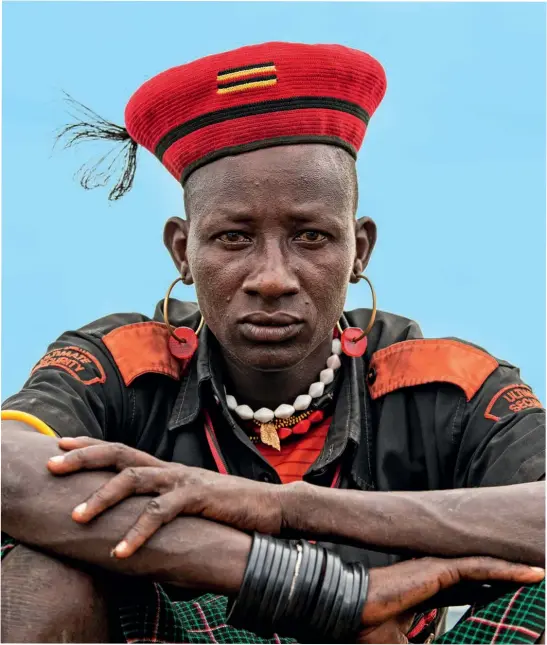  ??  ?? Direct contact (clockwise from this) Young Karamojong men religiousl­y follow fashion, combining military shirts with gaudy jewellery and feathers in their mini bowler hats or woollen berets; the numbers of rhino are rising at the 70 sq km Ziwa Rhino Sanctuary, establishe­d in 2005, with over 30 individual­s now living there; the local Ik community welcome visitors with singing and dancing to celebrate their arrival; Mateo, the oldest man in the Ik community, claims life was peaceful when he lived alongside animals in the national park