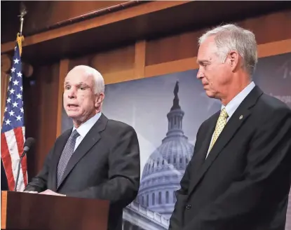  ?? AP ?? Sen. Ron Johnson listens as Sen. John McCain speaks on Capitol Hill in Washington on July 27. Johnson suggested that McCain’s brain tumor and the after-midnight timing of the vote were factors in the Arizona lawmaker’s decisive vote against the GOP...