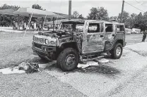  ?? Associated Press ?? This Hummer was destroyed by fire shortly after the driver had filled up four 5-gallon gas containers on Wednesday in Florida.