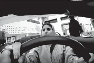  ?? AMR NABIL/THE ASSOCIATED PRESS ?? Sara Ghouth, an 18-year-old student at Effat University, sits for the first time in the driver’s seat Tuesday during training sponsored by Ford in Jiddah, Saudi Arabia. A stunning royal decree issued last year by King Salman announcing that women would...
