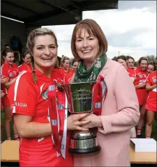  ??  ?? Camogie Uachtaran Kathleen Woods presents Cork’s Sarah Harrington the League 2 Trophy Photo by Inpho