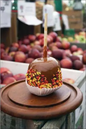  ?? PHOTO BY EMILY RYAN ?? Sprinkles add a festive touch to a Highland Orchards’ caramel apple.