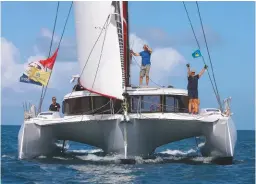  ??  ?? Above: the crew of Neel 47 trimaran Minimole celebrate arrival in St Lucia 12 days after leaving Mindelo, Cape Verde.
Below: crew of Wild Spirit (from left) Kevin Horne, Diane Rogers and Russell Finch