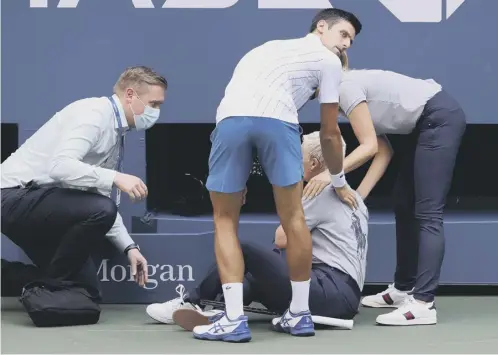  ?? PICTURE: AL BELLO/GETTY ?? 0 Novak Djokovic tends to a line judge after she was hit by his ball during his match against Pablo Carreno Busta.