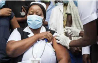  ??  ?? A medical worker receives the COVID-19 vaccine in Lusaka on April 14